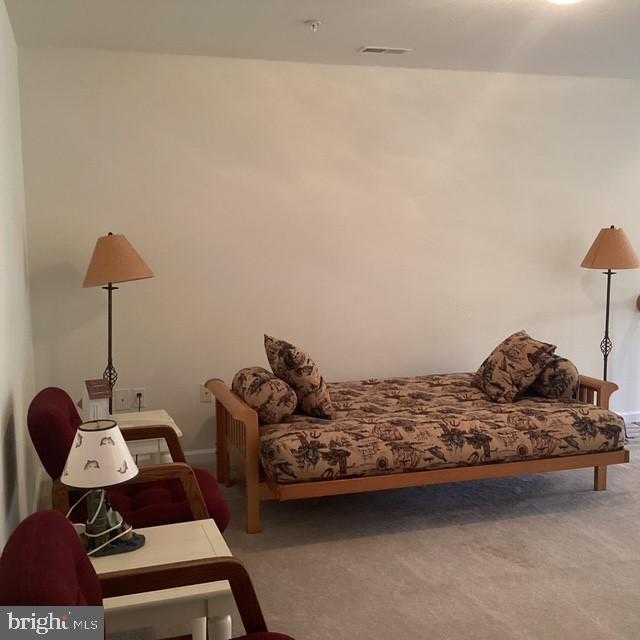 508 Summerset Court, Unit 33 Solomons, MD 20629 - Photo 20 of 36 a living room with furniture and a lamp