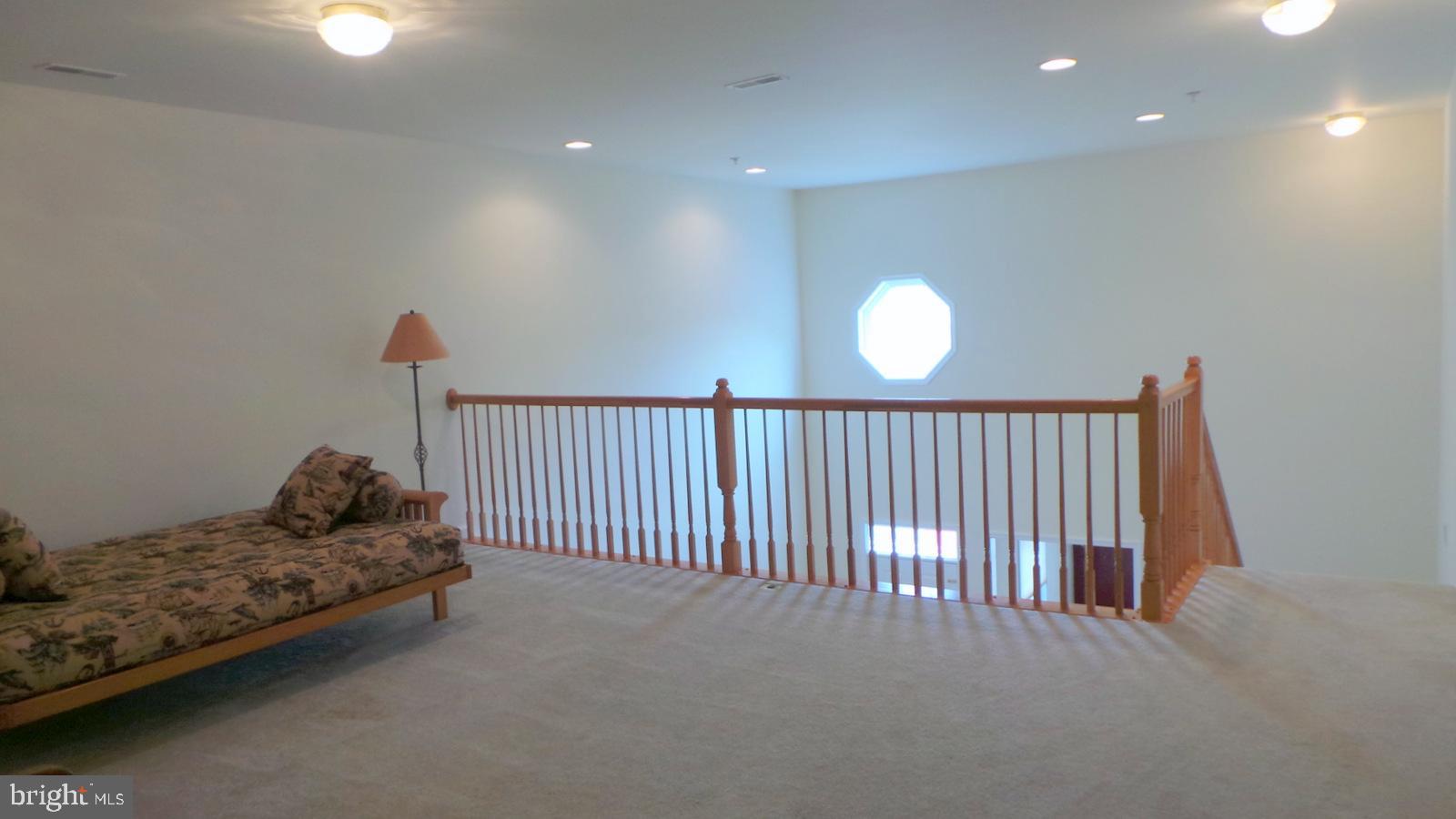 508 Summerset Court, Unit 33 Solomons, MD 20629 - Photo 22 of 36 a bedroom with bed and a chandelier