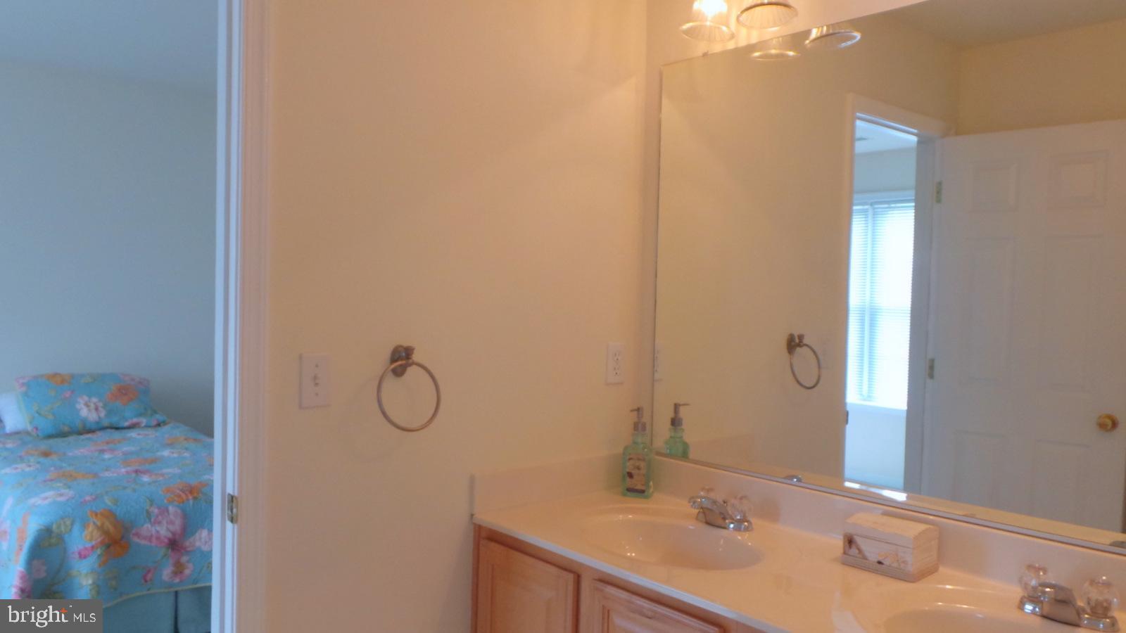 508 Summerset Court, Unit 33 Solomons, MD 20629 - Photo 24 of 36 a bathroom with a sink vanity and mirror