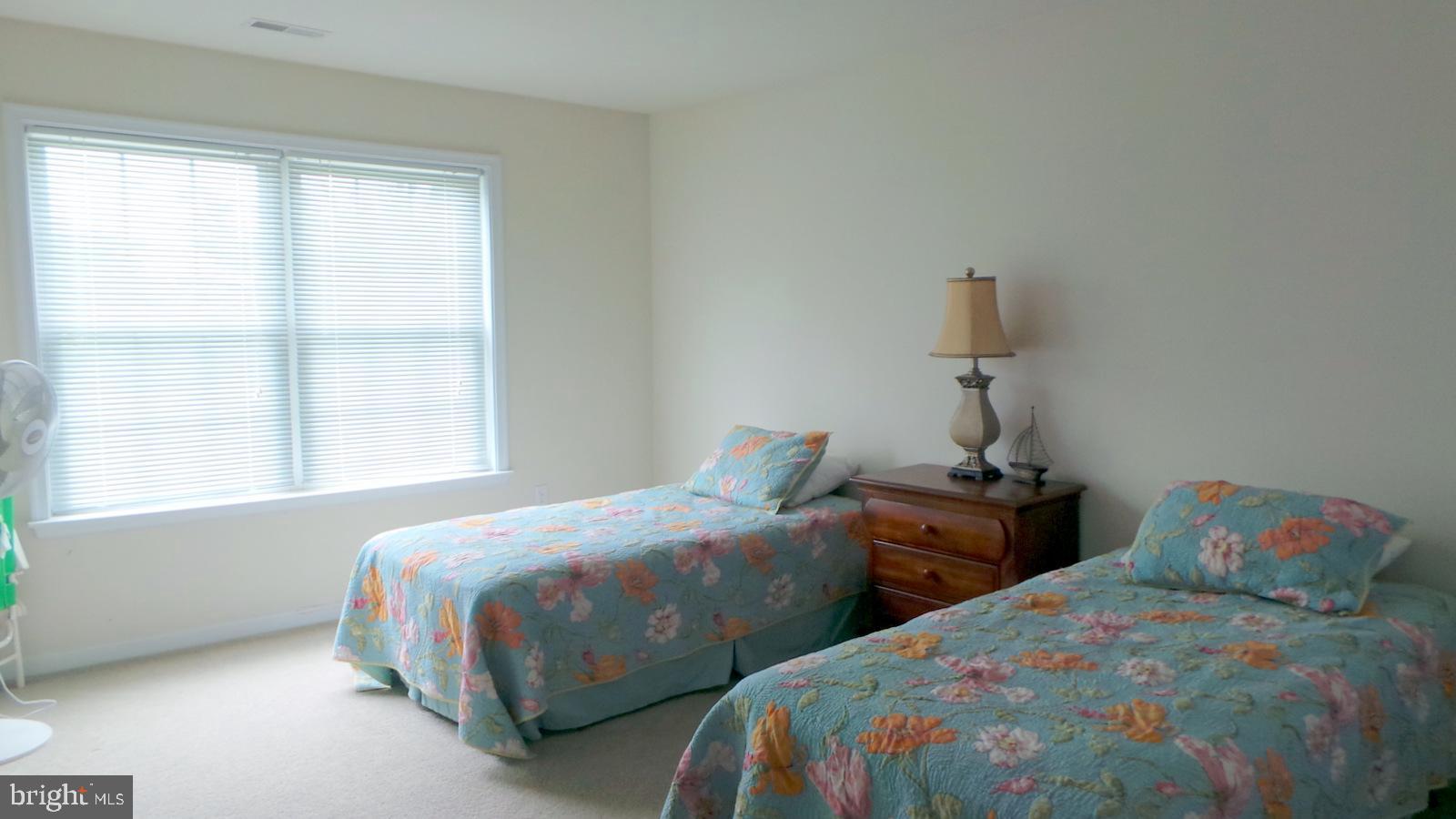 508 Summerset Court, Unit 33 Solomons, MD 20629 - Photo 25 of 36 a bedroom with two beds and a window