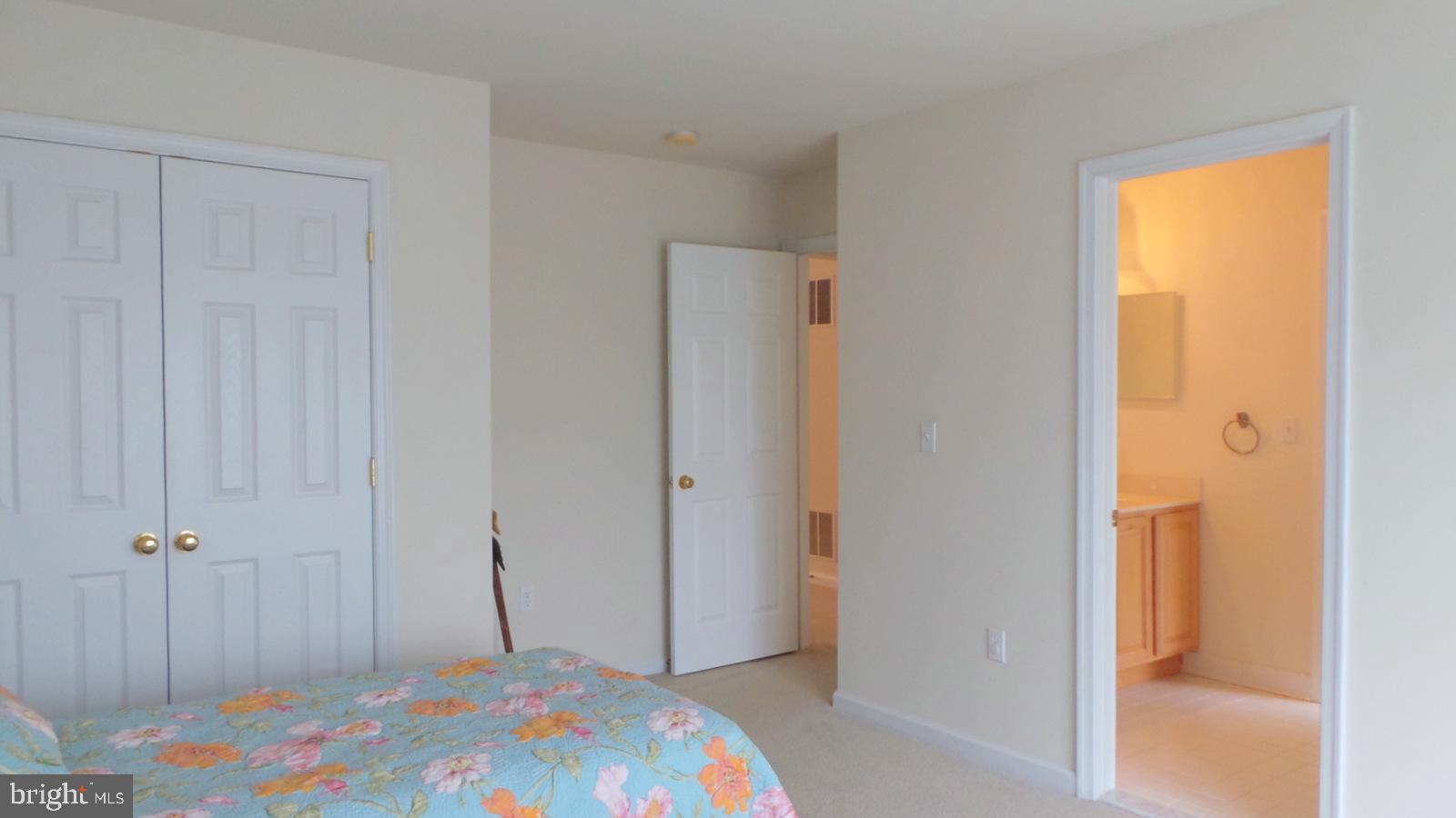 508 Summerset Court, Unit 33 Solomons, MD 20629 - Photo 26 of 36 a bedroom with a bed and hallway