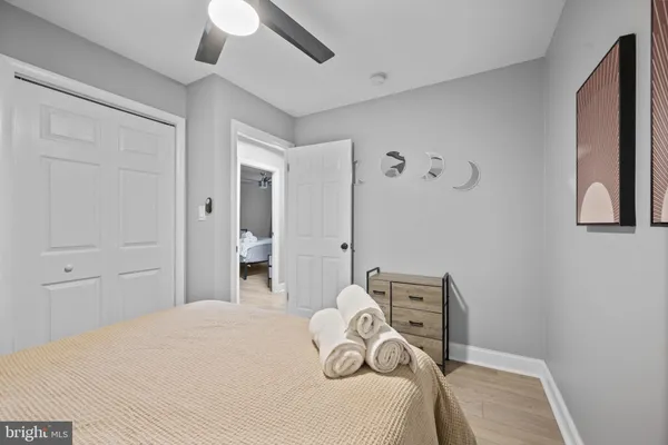 a bedroom with a large bed and a chandelier