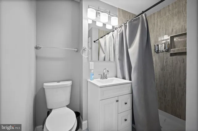 a bathroom with a toilet sink and shower