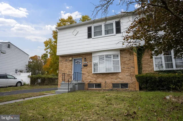 a house that has a tree in front of the house