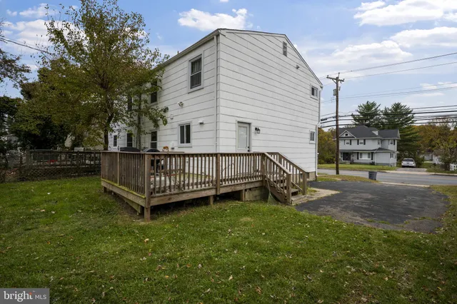 a view of a house with a yard and deck