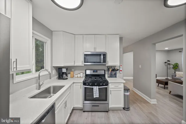 a kitchen with a sink stove and cabinets