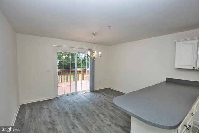 a view of a room with a window and wooden floor