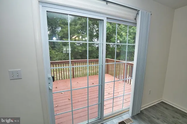a view of a workspace with wooden floor and a window