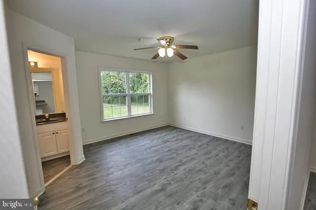 a kitchen with kitchen island white cabinets and refrigerator