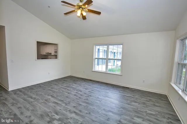 a bathroom with a granite countertop sink and a toilet
