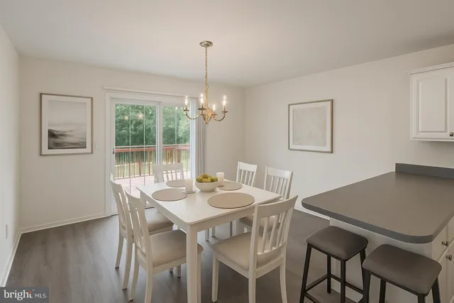 a kitchen with granite countertop white cabinets white appliances and sink
