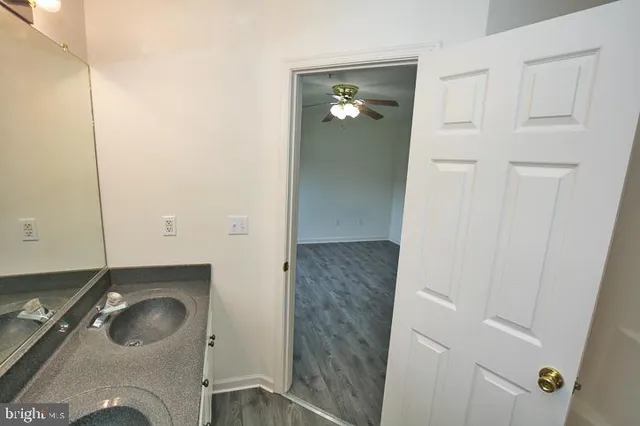 a view of a house with a yard and potted plants
