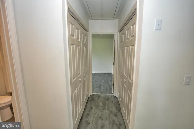 a aerial view of a house next to a big yard and large trees