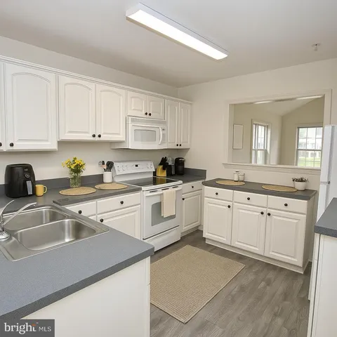 a kitchen with a sink stove and cabinets