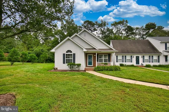 an aerial view of a house with a yard and trees