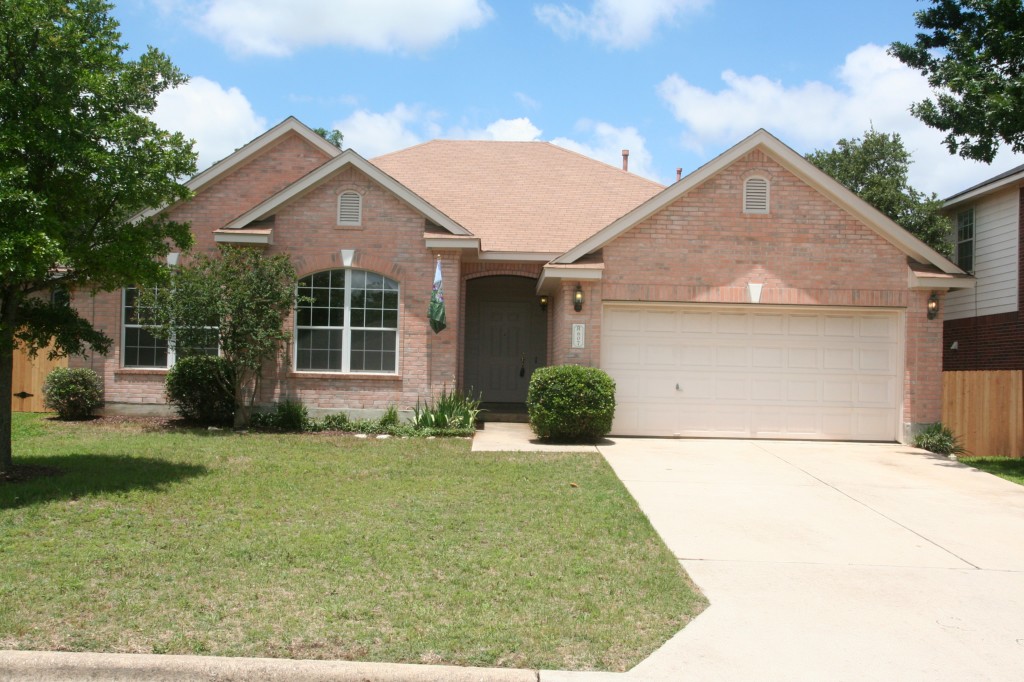 607 Spring Brook Lane Leander, TX 78641 - Photo 1 of 1 a front view of a house with a garden and yard