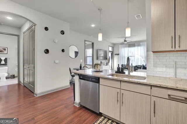 a kitchen with cabinets and wooden floor