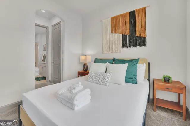 a bedroom with a bed and a painting on the wall