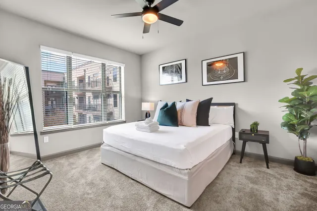 a spacious bedroom with a bed and a table