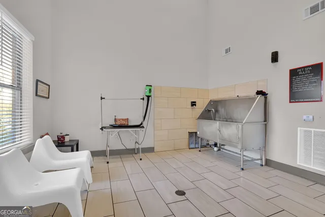 a living room with furniture and a dining table