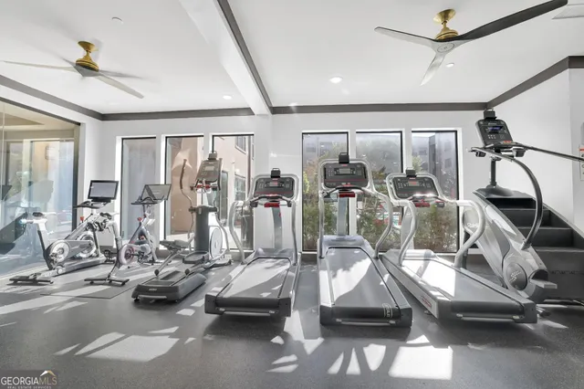 a room with gym equipment and windows