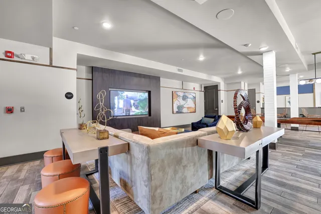 a living room with furniture and wooden floor