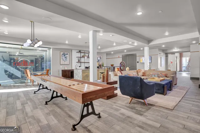 a living room with furniture a rug and a chandelier