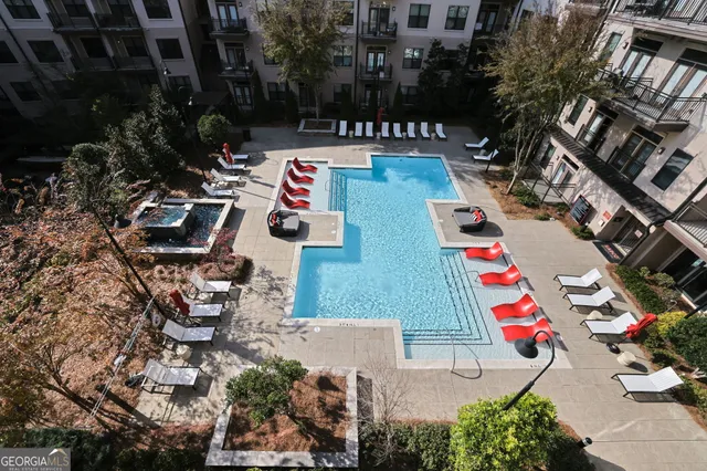 an aerial view of a pool patio fire pit and outdoor seating