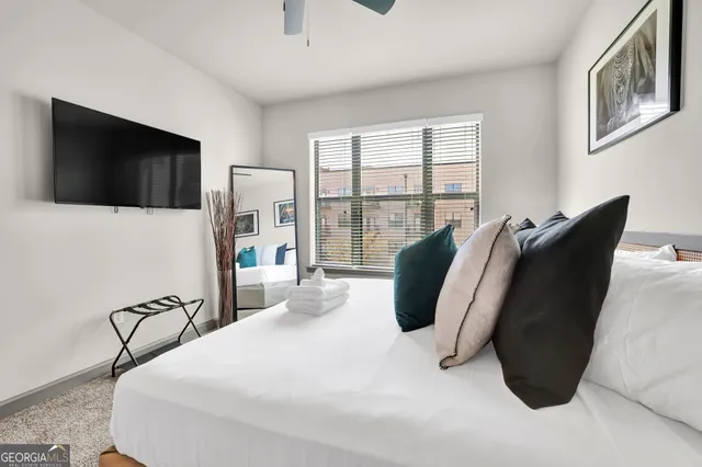 a bedroom with a bed and a flat screen tv