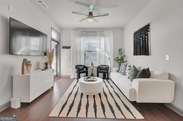 a living room with furniture and a large window