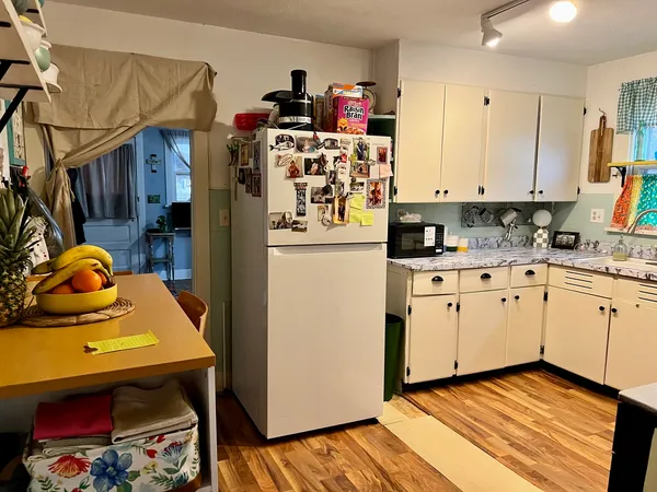 a kitchen with a refrigerator and cabinets
