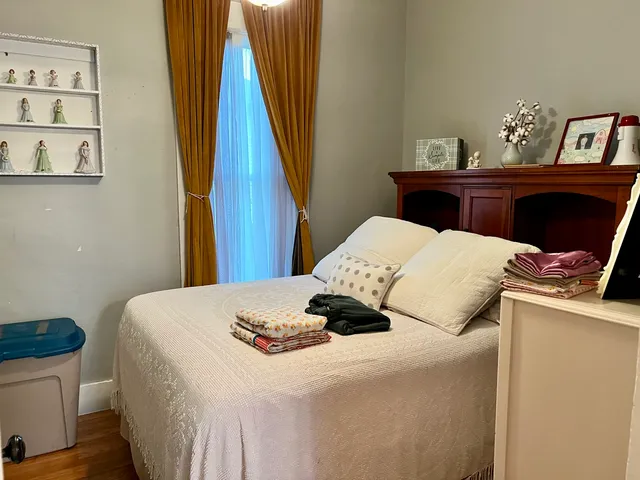 a bedroom with a bed and a table