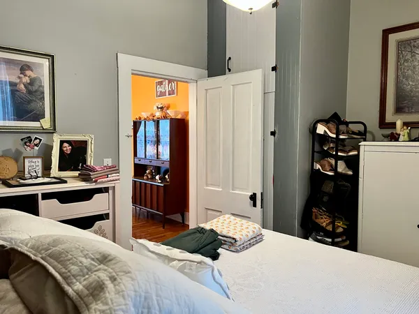 a bedroom with a bed and a flat tv screen