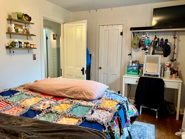 a bedroom with a bed and a desk