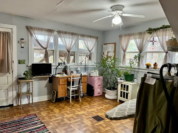 a living room with furniture a flat screen tv and a floor to ceiling window