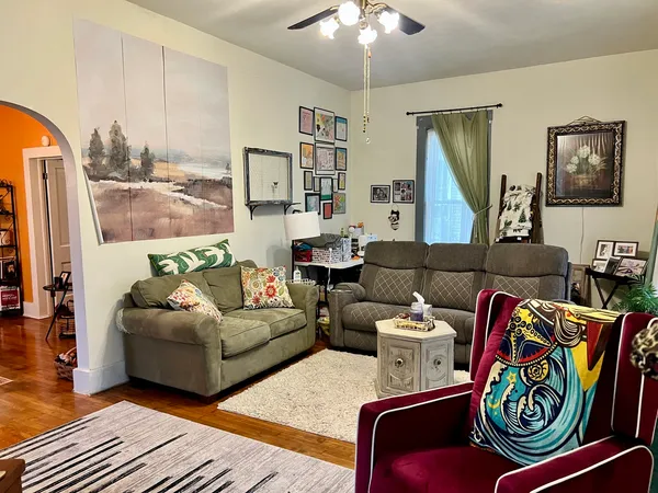 a living room with furniture and a flat screen tv