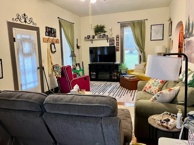 a living room with furniture and a flat screen tv