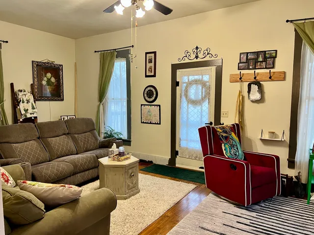 a living room with furniture and wooden floor