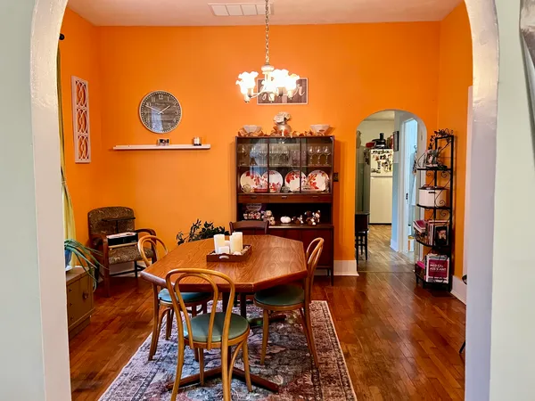 a view of a dining room with furniture and chandelier