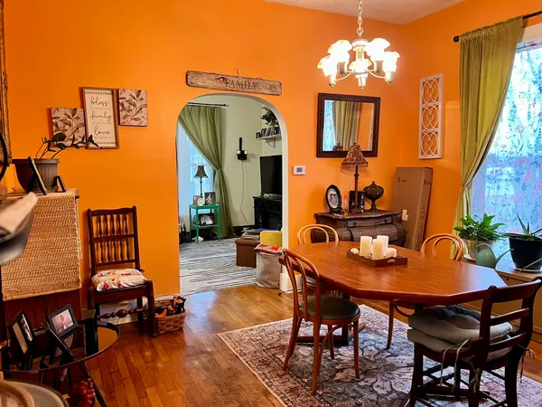a dining room with furniture and wooden floor