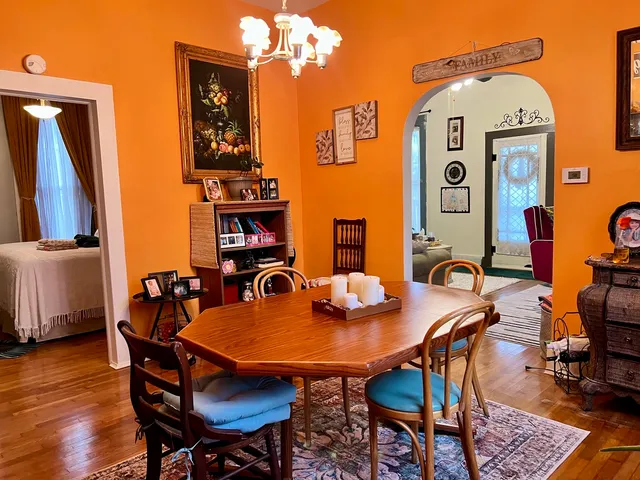 a view of a dining room with furniture and wooden floor