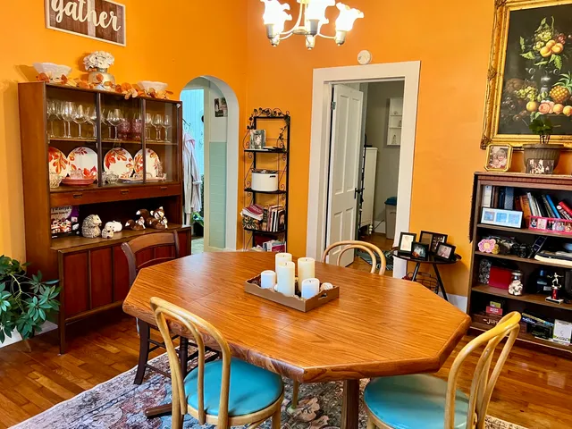 a view of a dining room with furniture and chandelier