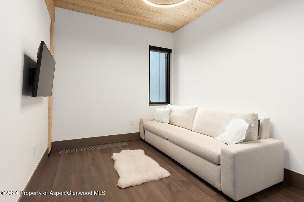 180 Wood Road, Unit 302 Snowmass Village, CO 81615 - Photo 22 of 43 a living room with furniture and a flat screen tv