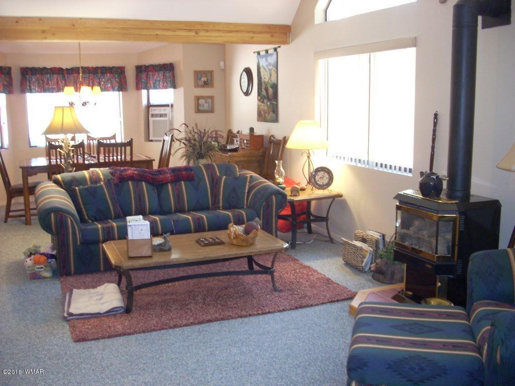 2101 Chevelon Road Overgaard, AZ 85933 - Photo 14 of 45 a living room with furniture and a fireplace