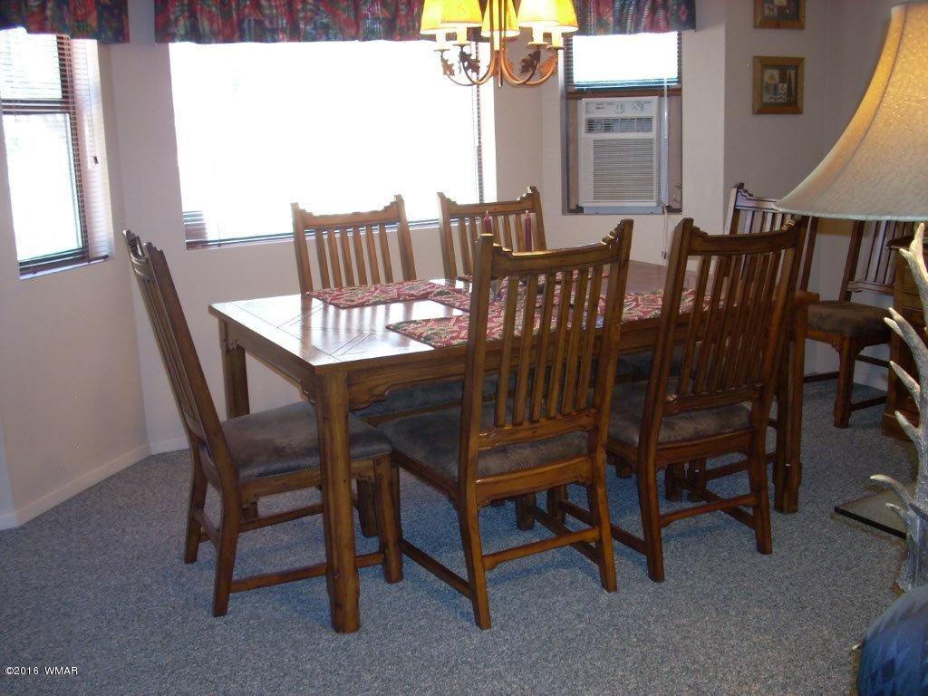 2101 Chevelon Road Overgaard, AZ 85933 - Photo 15 of 45 a view of a dining room with furniture window and outside view