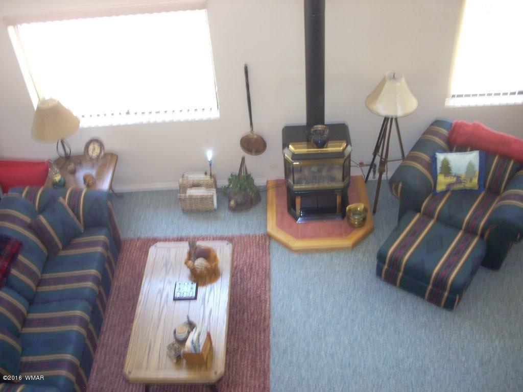 2101 Chevelon Road Overgaard, AZ 85933 - Photo 20 of 45 a dining room with furniture and wooden floor