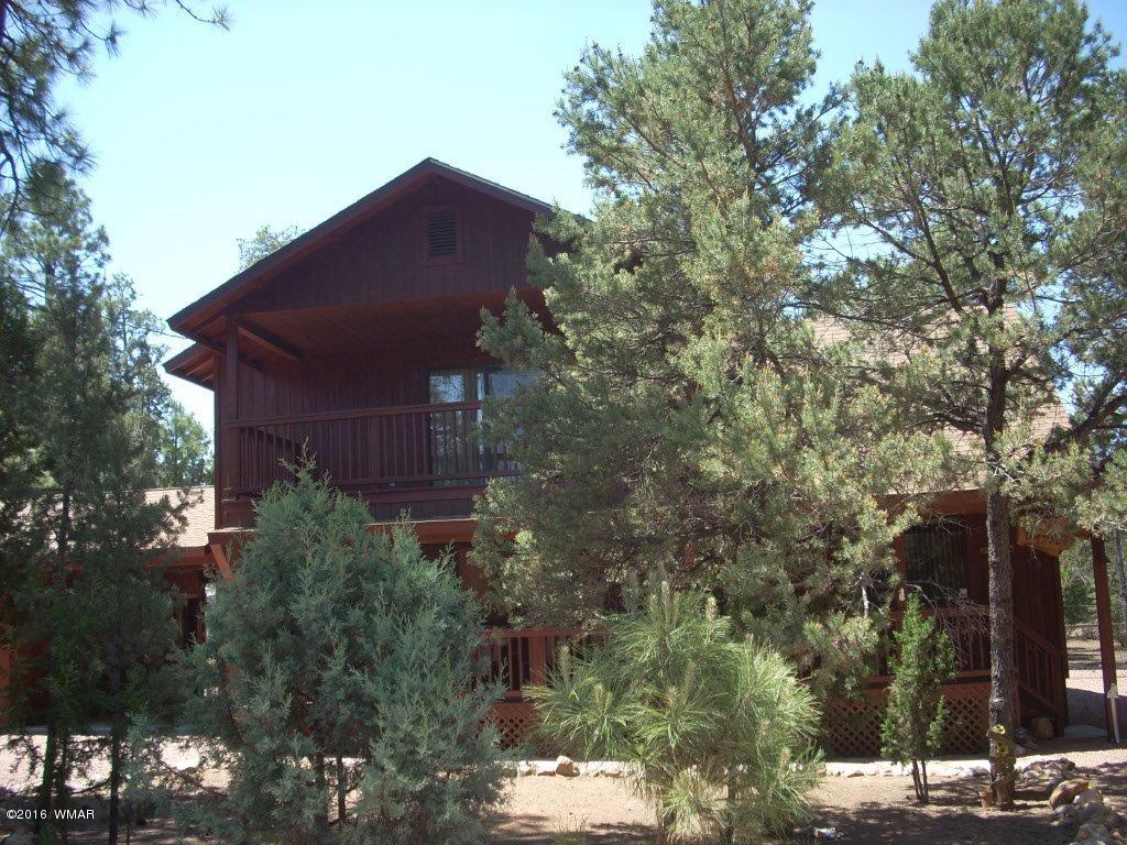 2101 Chevelon Road Overgaard, AZ 85933 - Photo 2 of 45 a tall building with trees in front of it