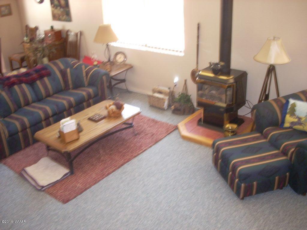 2101 Chevelon Road Overgaard, AZ 85933 - Photo 22 of 45 a living room with furniture and a lamp