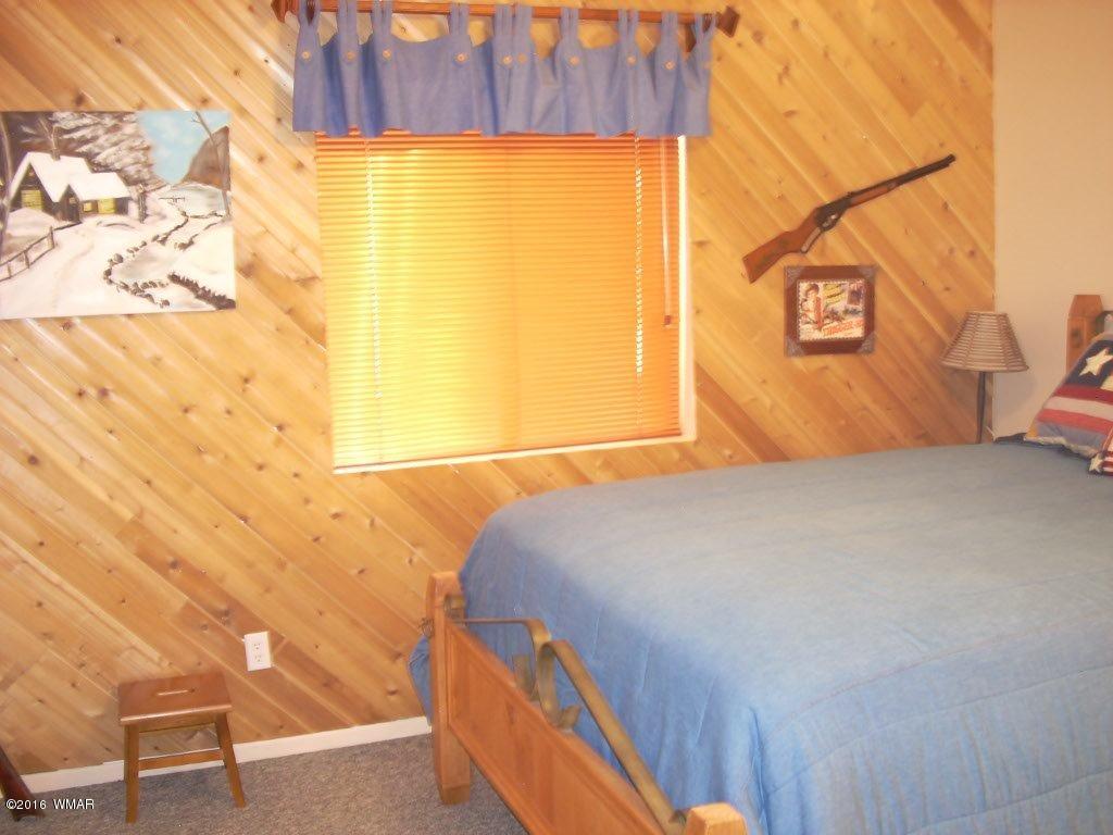 2101 Chevelon Road Overgaard, AZ 85933 - Photo 24 of 45 a bedroom with a bed and a window