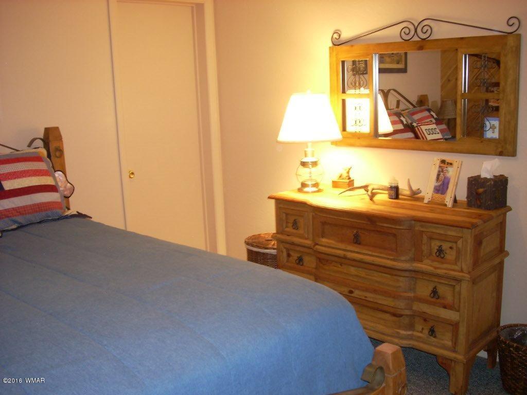 2101 Chevelon Road Overgaard, AZ 85933 - Photo 25 of 45 a bedroom with a bed and a painting on the wall